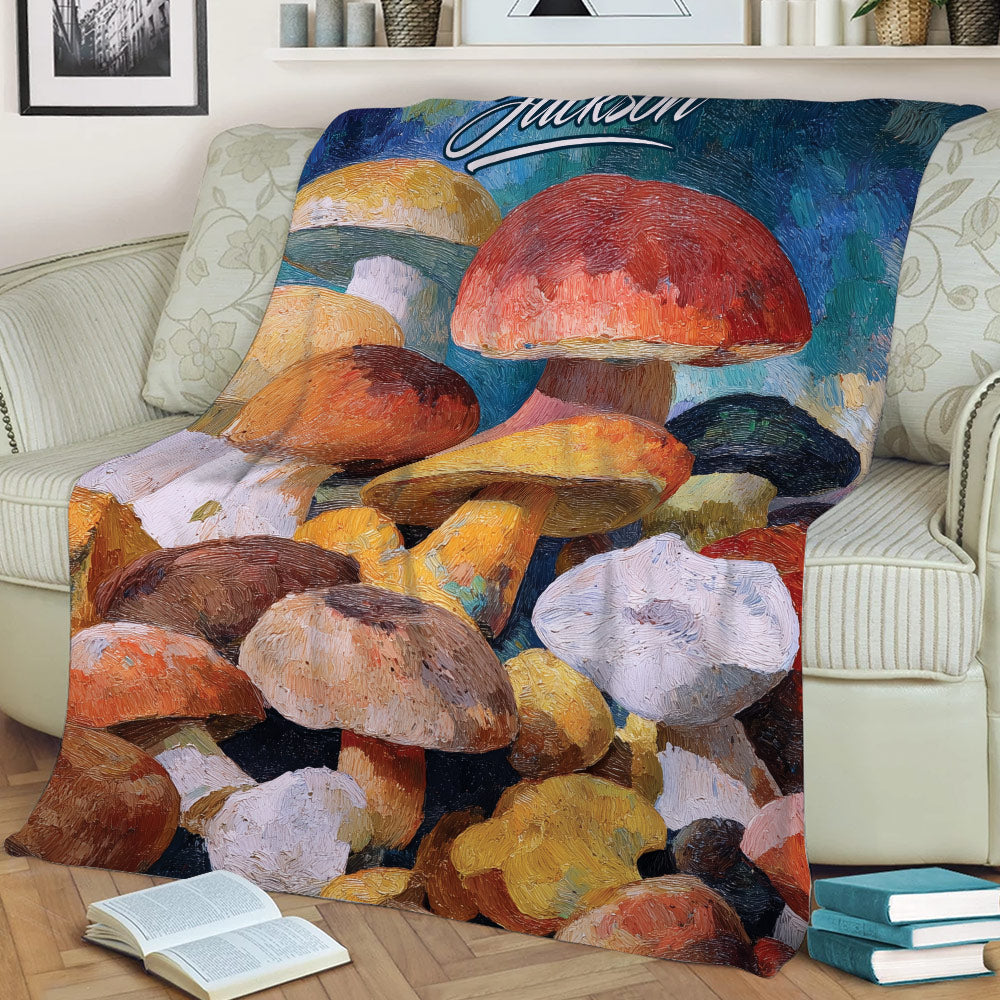 Close view of a mushroom throw blanket styled on a sofa with painterly fungi artwork