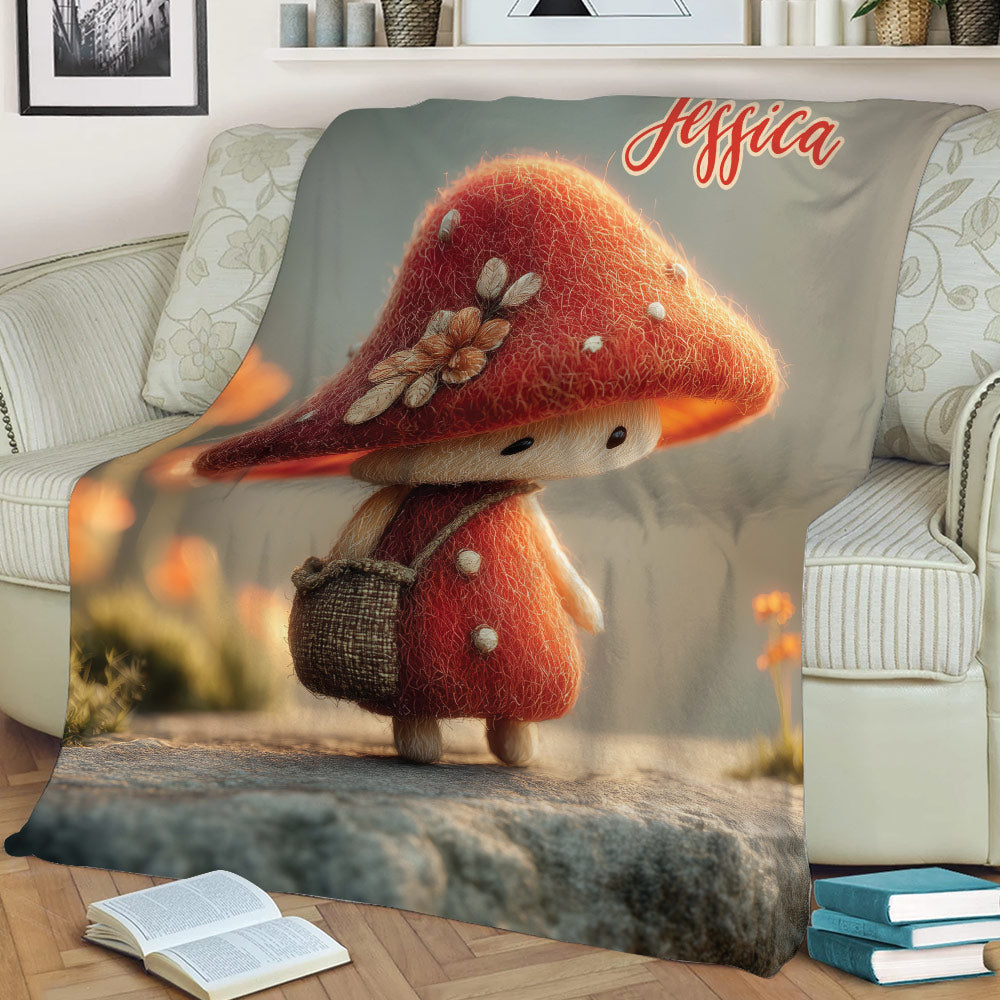 Whimsical mushroom artwork blanket styled over a sofa with books nearby