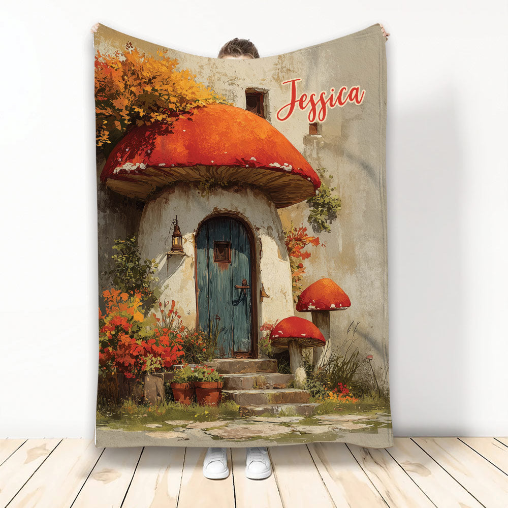 Mushroom cottage blanket with red toadstools, autumn flowers, and storybook garden artwork