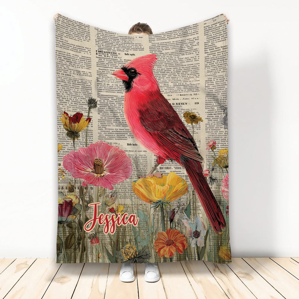 Cardinal throw blanket with red bird and colorful flowers on a vintage book page background