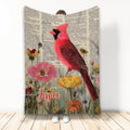 Cardinal throw blanket with red bird and colorful flowers on a vintage book page background