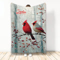 Cardinal throw blanket featuring two red cardinals on a snowy branch with winter berries
