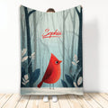 Cardinal throw blanket featuring a red bird in a snowy woodland scene with soft blue-gray forest tones