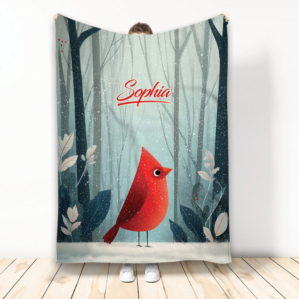 Cardinal throw blanket featuring a red bird in a snowy woodland scene with soft blue-gray forest tones