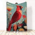 Red cardinal blanket with botanical foliage and muted teal background shown in a full product display