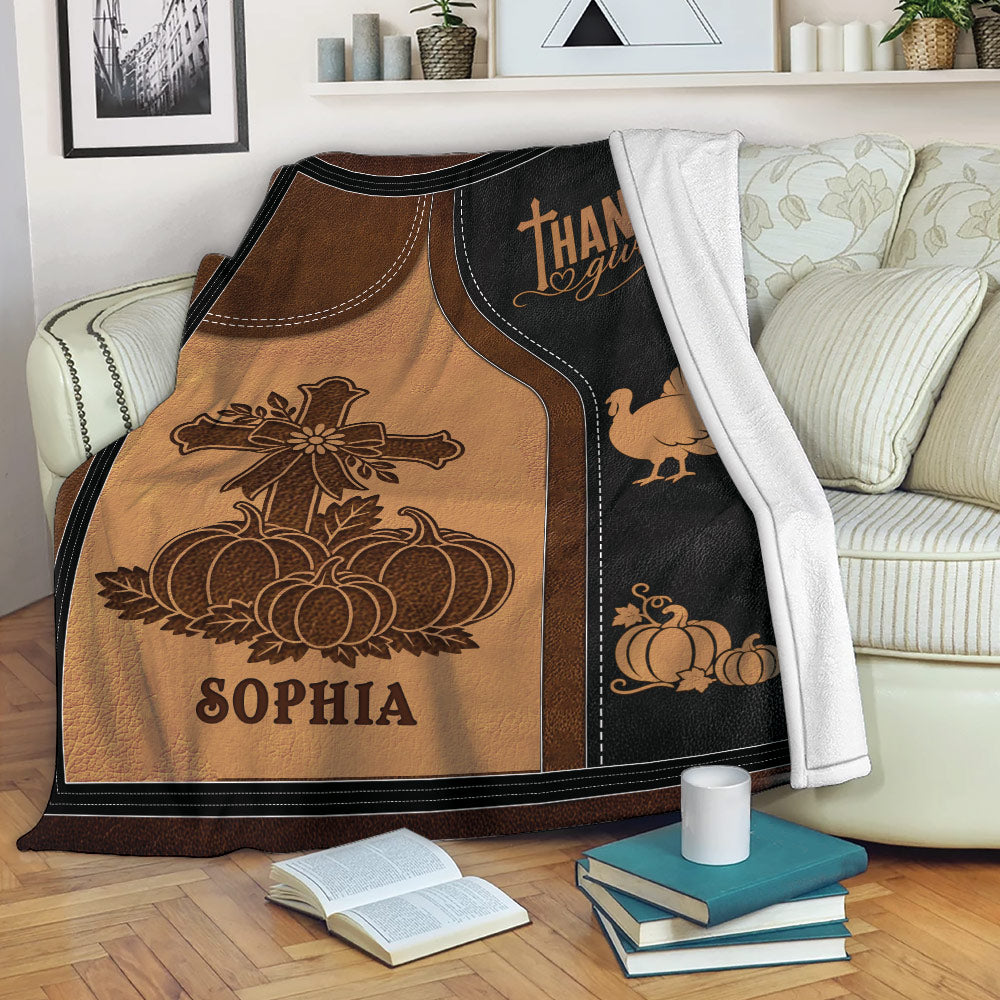 Rustic Thanksgiving throw blanket displayed on a sofa with pumpkins, turkey, and autumn artwork