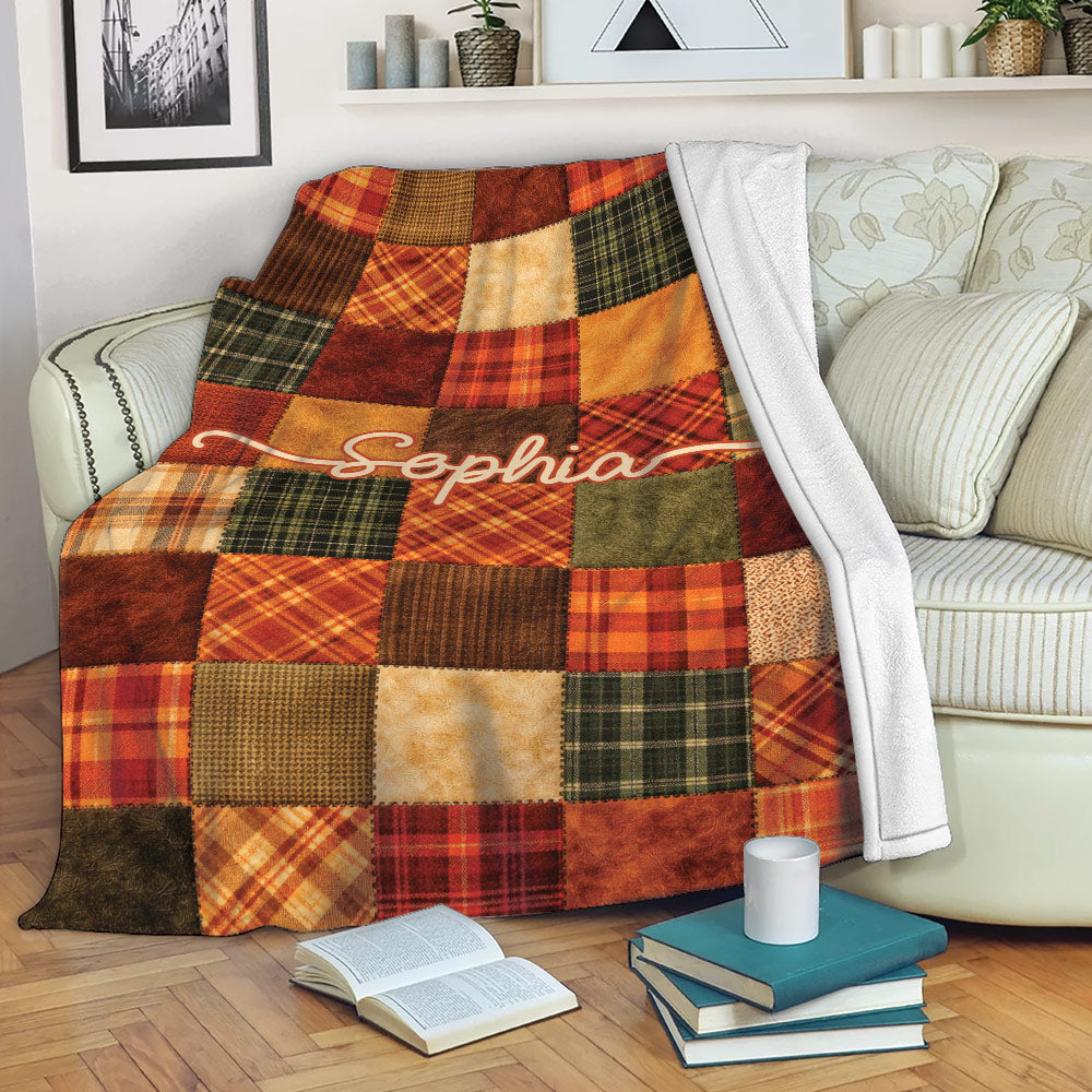 Thanksgiving plaid throw blanket styled across a sofa with books and a mug in a cozy room