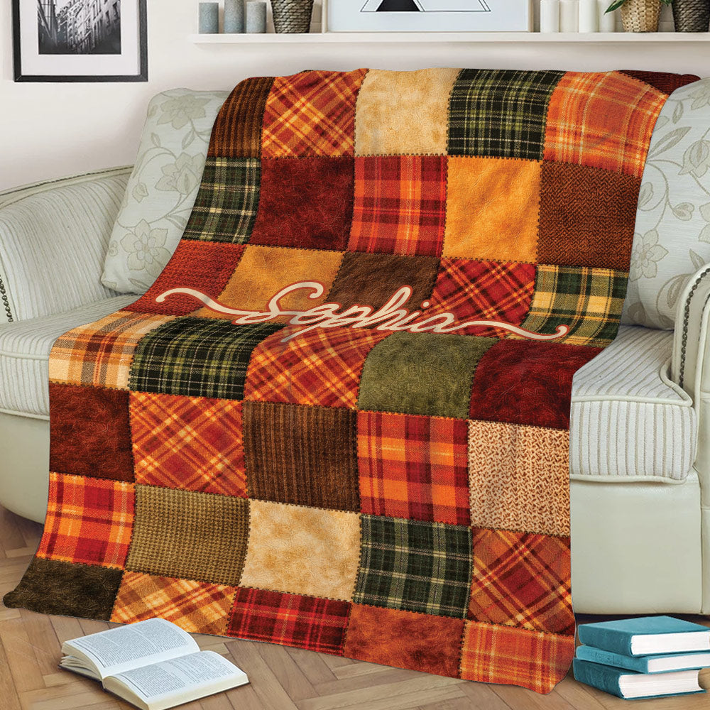 Autumn Thanksgiving throw blanket draped over a sofa with colorful plaid patchwork design