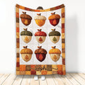 Thanksgiving blanket with colorful acorns, autumn leaves, pumpkins, and a warm fall patchwork border