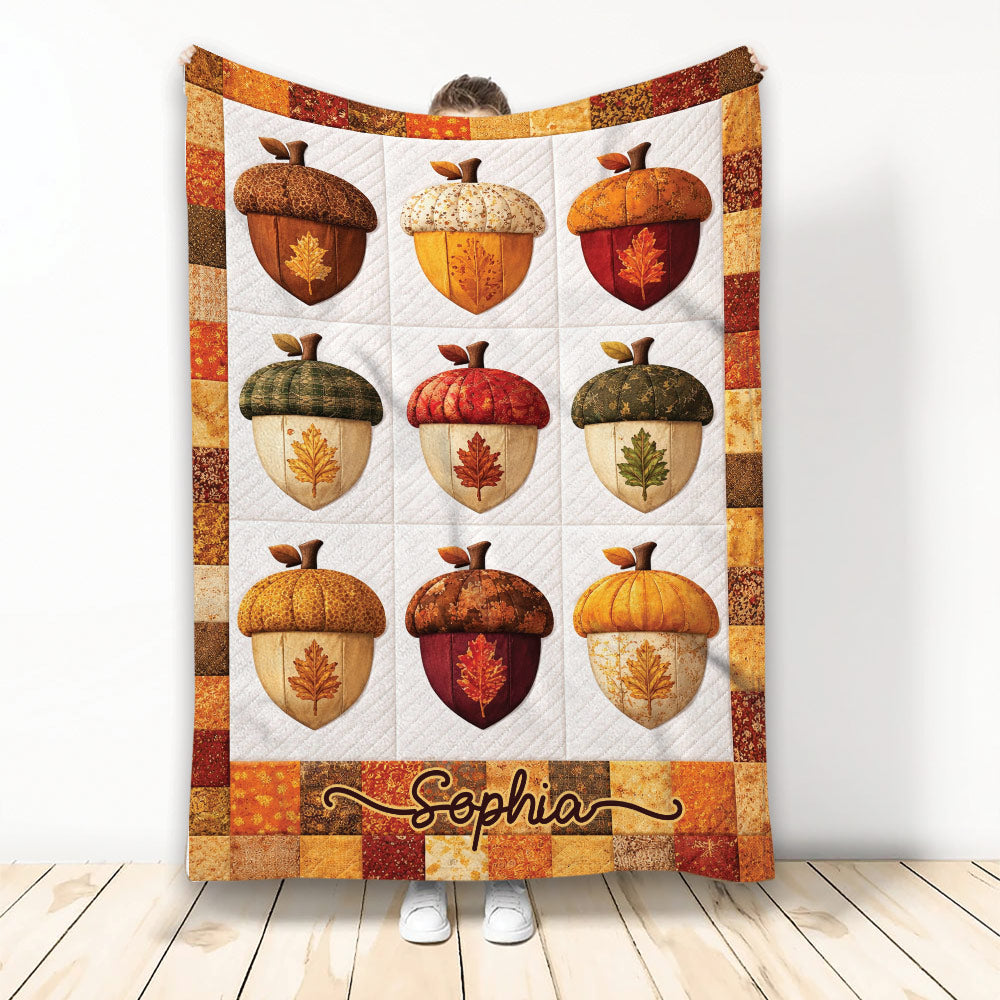 Thanksgiving blanket with colorful acorns, autumn leaves, pumpkins, and a warm fall patchwork border