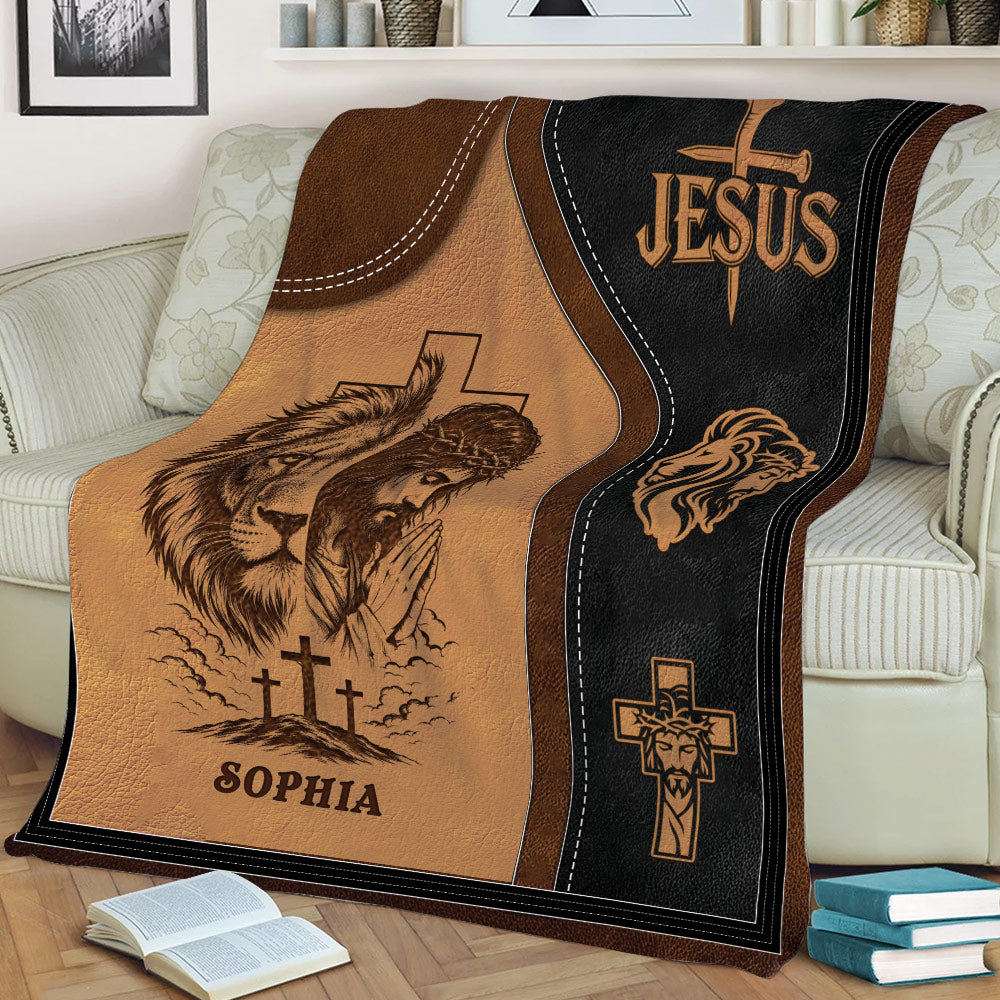 Close view of a Christian throw blanket featuring Jesus, crosses, lion imagery, and dark rustic tones