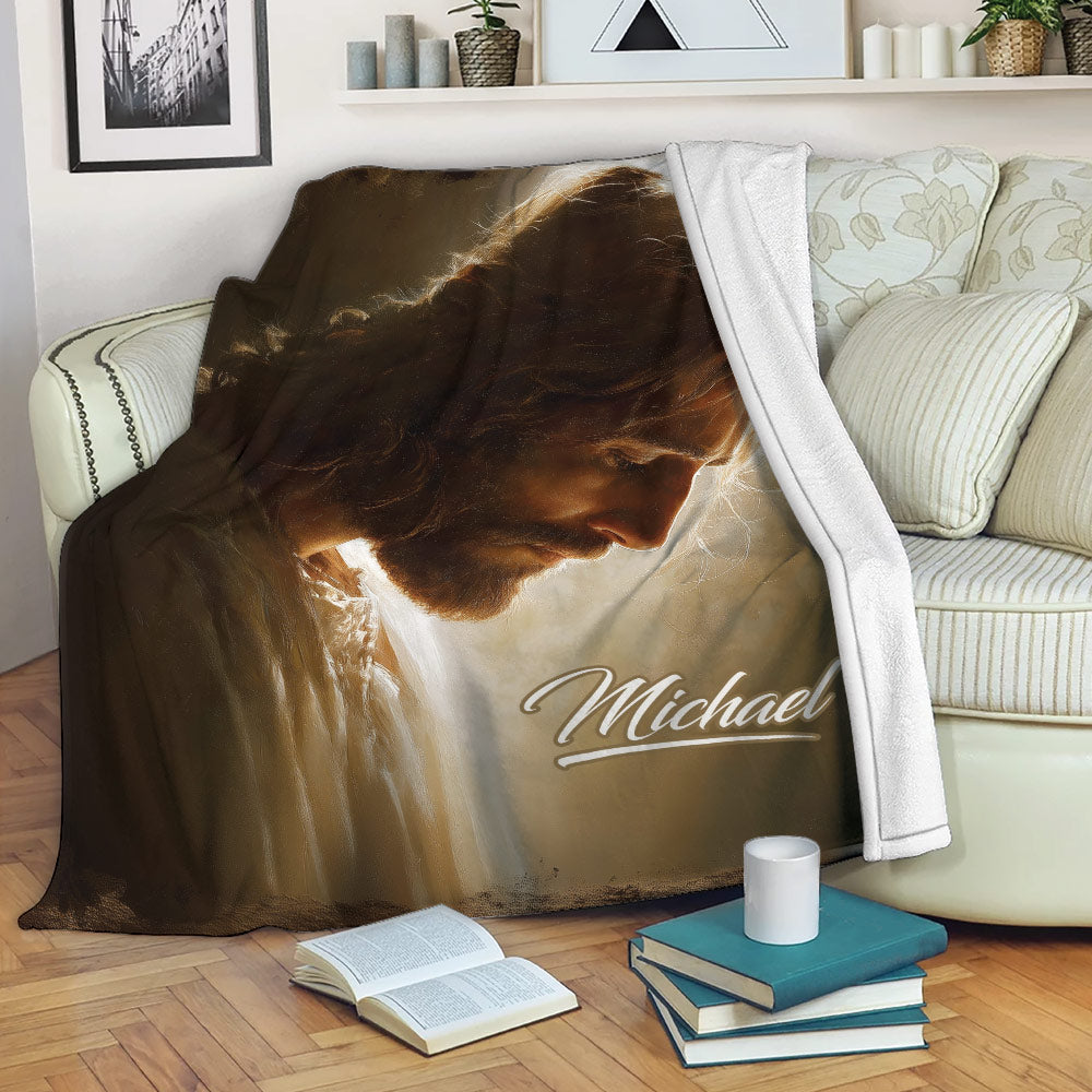 Christian throw blanket featuring Jesus artwork styled on a cozy living room sofa