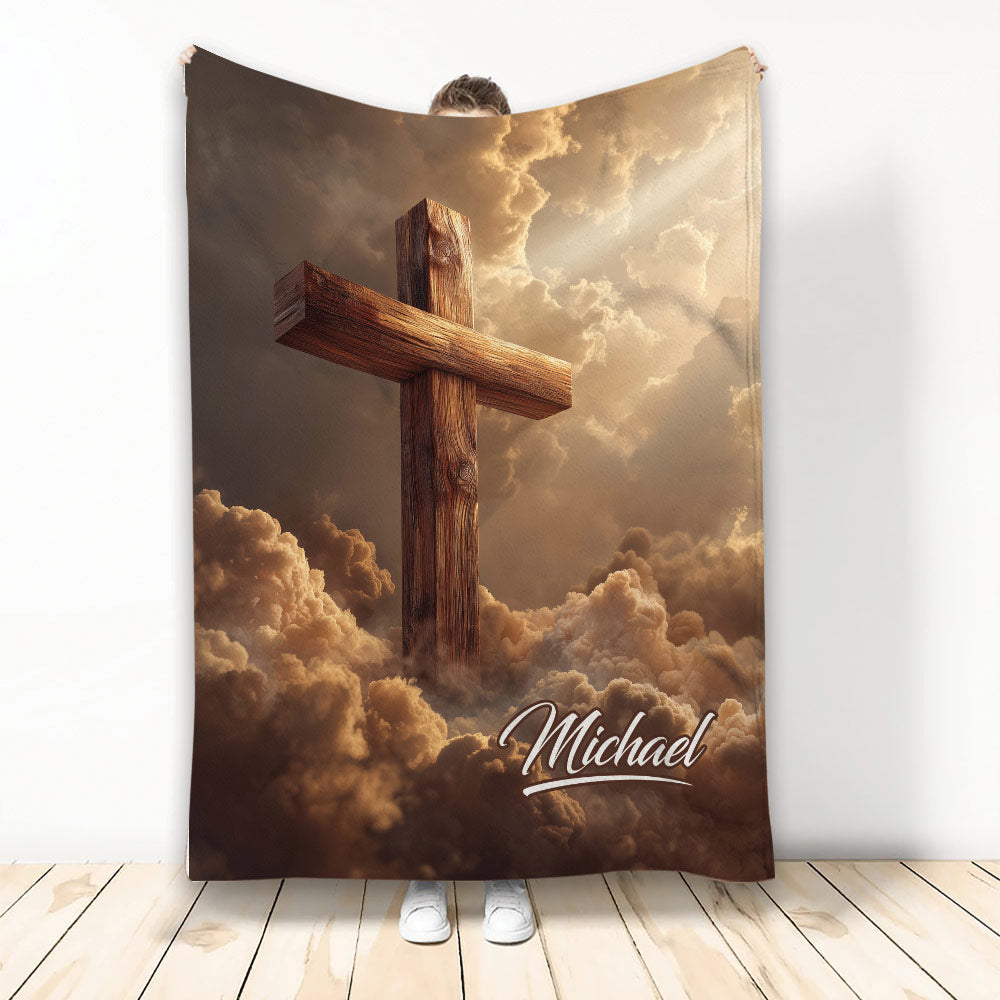 Christian cross throw blanket featuring a wooden cross rising through dramatic golden clouds
