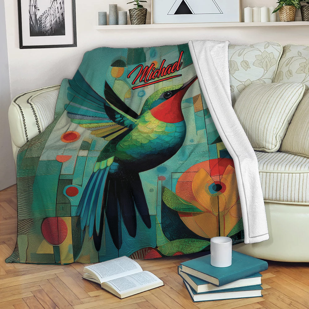 Colorful hummingbird blanket draped over a sofa in a cozy reading room setting