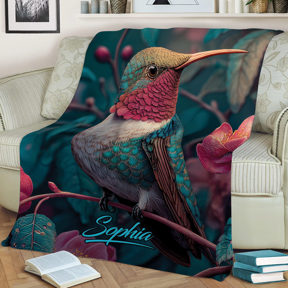 Colorful hummingbird blanket displayed on a sofa with tropical flowers and botanical details