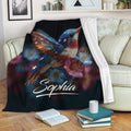Hummingbird throw blanket displayed on a sofa with colorful floral artwork
