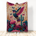 Colorful hummingbird blanket with pink flowers, butterflies, cacti, and Southwestern botanical artwork