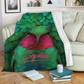 Colorful hummingbird blanket draped over a sofa in a cozy living room setting