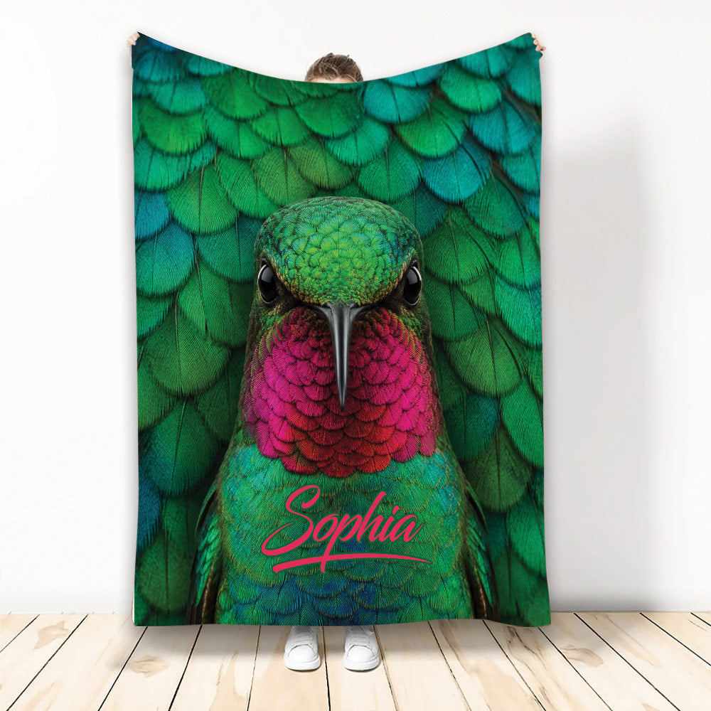 Colorful hummingbird throw blanket displayed with vibrant green, teal, and pink feather artwork