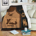 Siamese cat blanket draped over a sofa with vintage cat illustrations and cozy living room styling