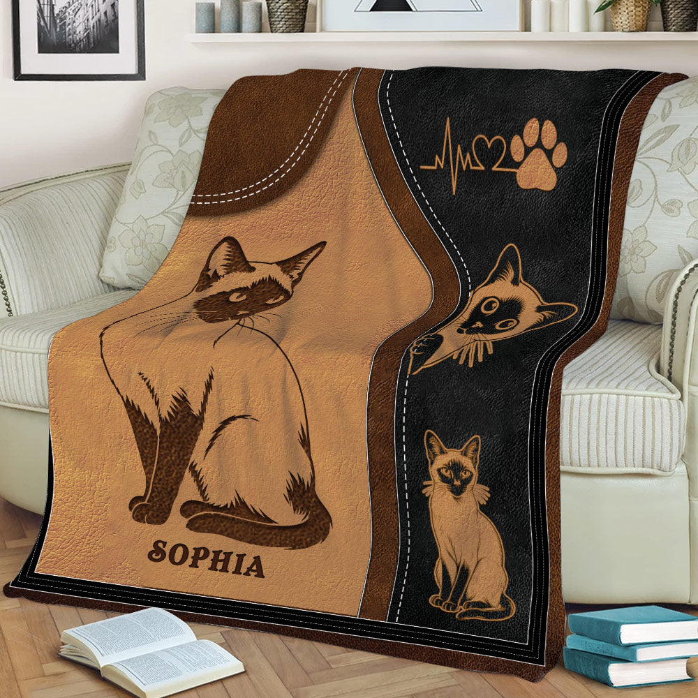 Close view of a Siamese cat throw blanket featuring detailed cat artwork in a warm brown and black design