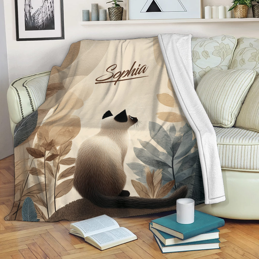 Siamese cat throw blanket draped over a sofa in a cozy reading room