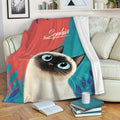 Siamese cat throw blanket draped over a sofa with colorful cat artwork and cozy reading nook