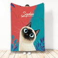 Siamese cat blanket with blue-eyed cat artwork, colorful red and teal background, and leafy accents