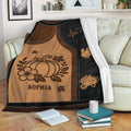 Autumn pumpkin throw blanket draped over a sofa with harvest and turkey artwork in warm earthy colors