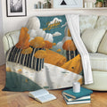Autumn forest throw blanket draped over a sofa with orange foliage, layered hills, and cozy living room decor