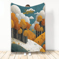 Autumn throw blanket with a custom design featuring orange trees, rolling hills, clouds, and a woodland path