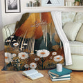 Autumn forest blanket draped over a sofa with golden foliage and daisy meadow artwork