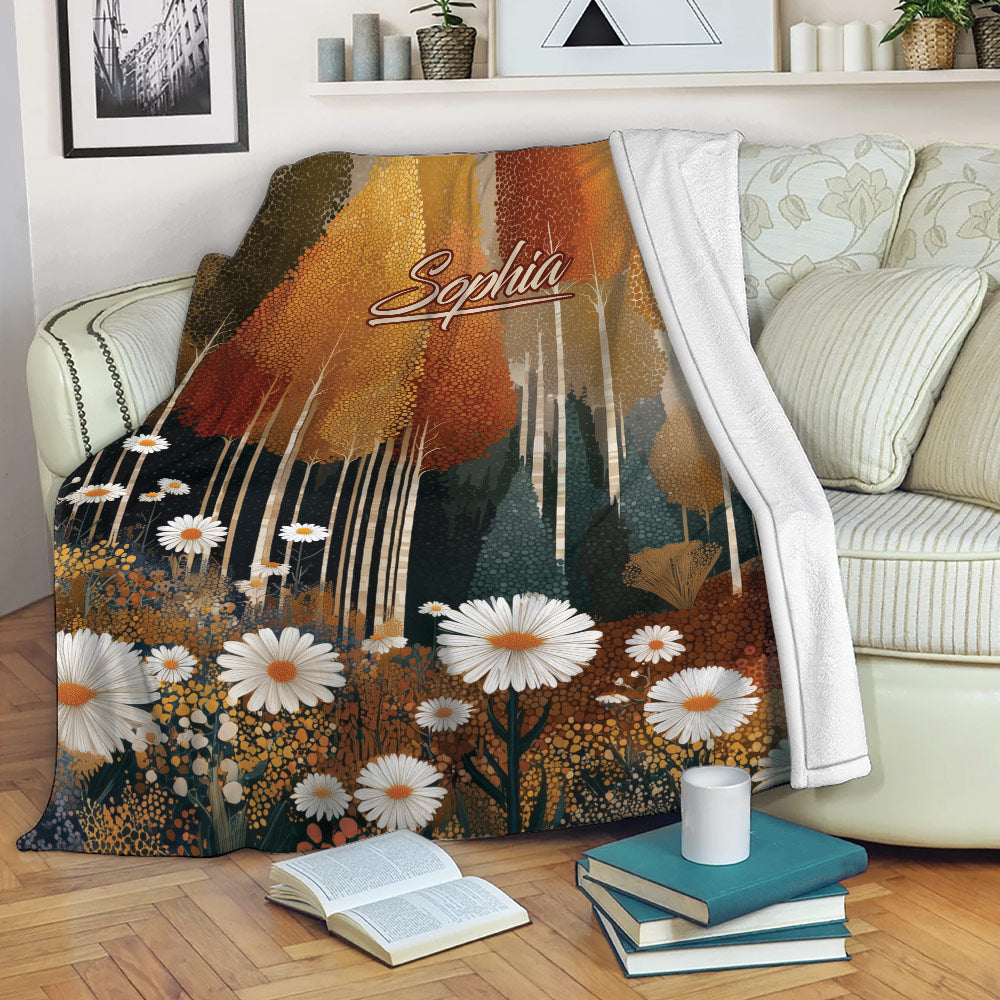 Autumn forest blanket draped over a sofa with golden foliage and daisy meadow artwork
