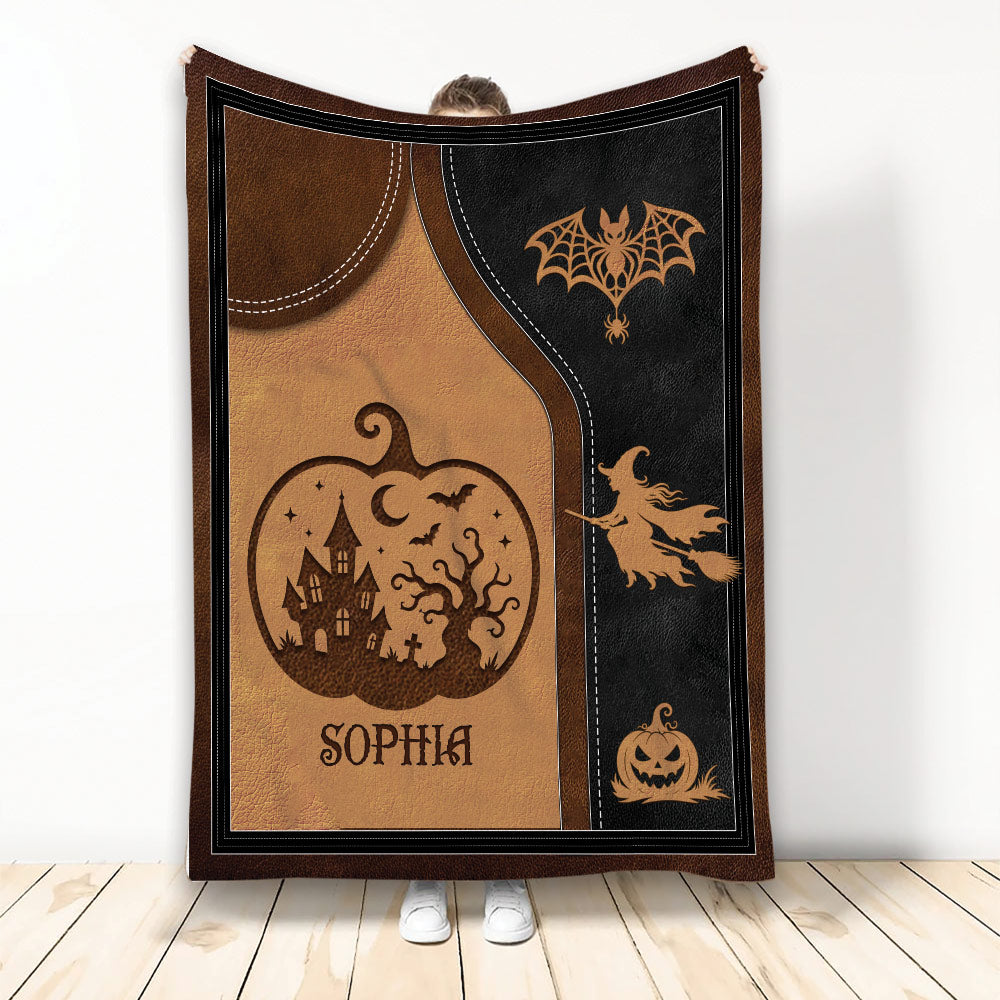 Halloween blanket with witch, pumpkins, bats, haunted house, spiderwebs, and a custom design in black and brown
