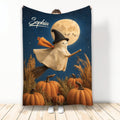 Halloween blanket featuring a friendly ghost witch on a broom above pumpkins under a moonlit sky