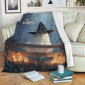 Halloween throw blanket with ghost witch artwork and glowing pumpkins styled on a living room sofa