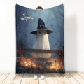 Halloween blanket featuring a ghost in a witch hat, bats, glowing pumpkins, and a spooky blue forest