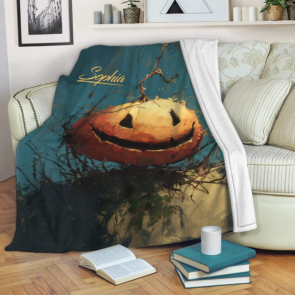 Halloween pumpkin throw blanket draped over a sofa with a dark teal and orange jack-o'-lantern design