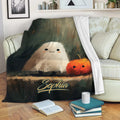 Halloween ghost and pumpkin throw blanket displayed on a cozy sofa with books and home decor