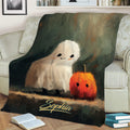 Cute ghost and pumpkin Halloween blanket draped over a sofa in a cozy living room