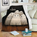 Spooky ghost Halloween blanket draped over a sofa in a cozy living room