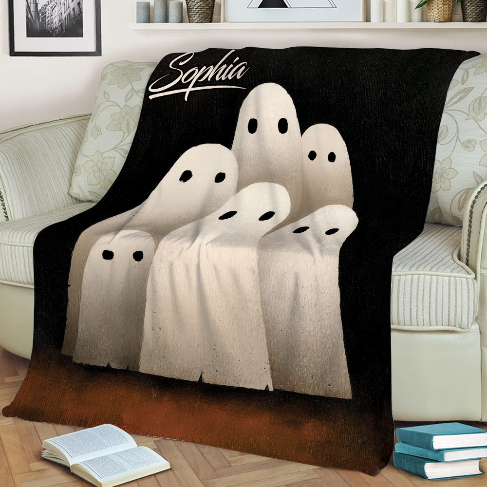 Halloween ghost throw blanket displayed across a sofa with a dark spooky design