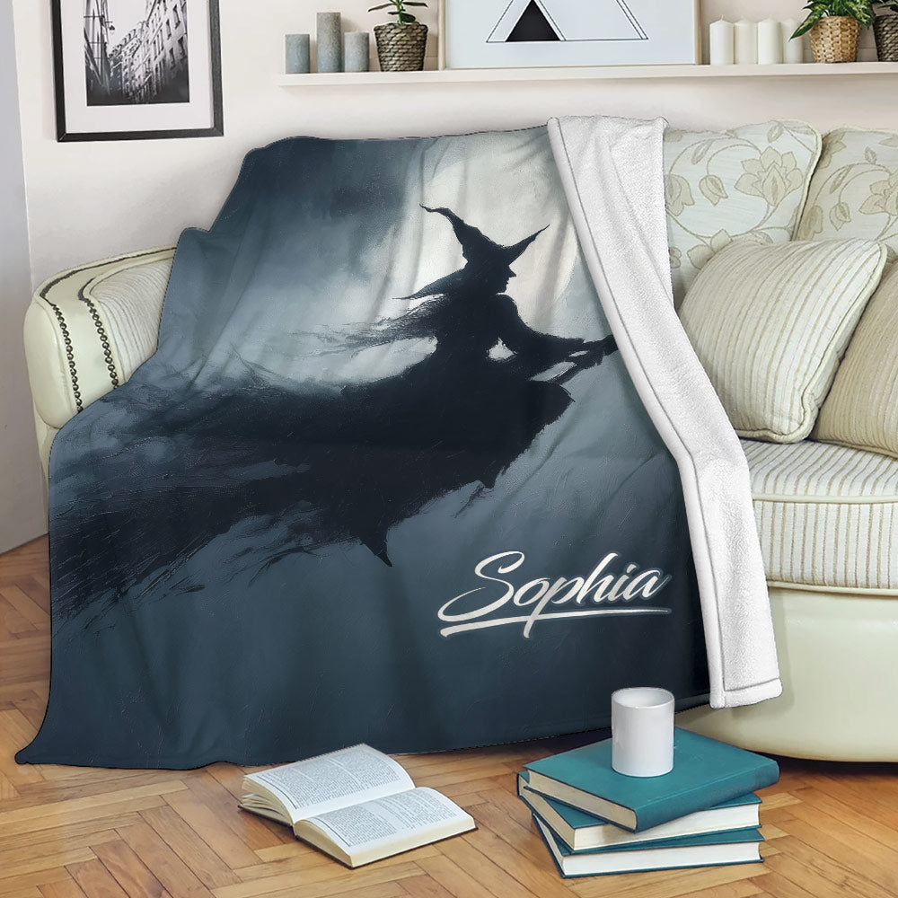 Halloween witch throw blanket draped over a sofa in a cozy living room setting