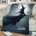 Moonlit witch Halloween blanket displayed across a sofa with dark atmospheric artwork