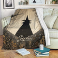 Halloween throw blanket draped over a sofa with spooky witch and woodland artwork