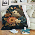 Hedgehog throw blanket displayed on a sofa with floral woodland artwork