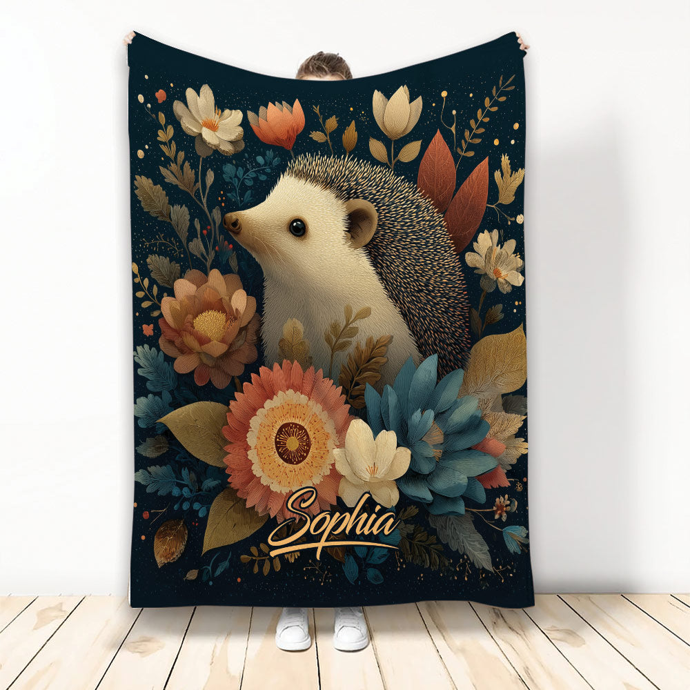 Hedgehog blanket with colorful floral artwork on a dark botanical background