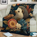 Floral hedgehog blanket draped over a sofa in a cozy living room