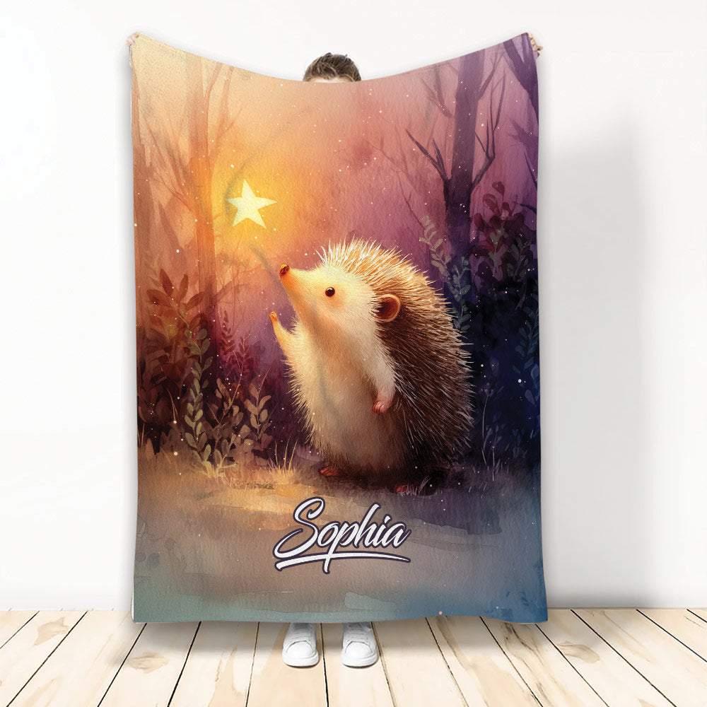 Hedgehog throw blanket featuring a whimsical woodland scene, glowing star, and warm watercolor colors