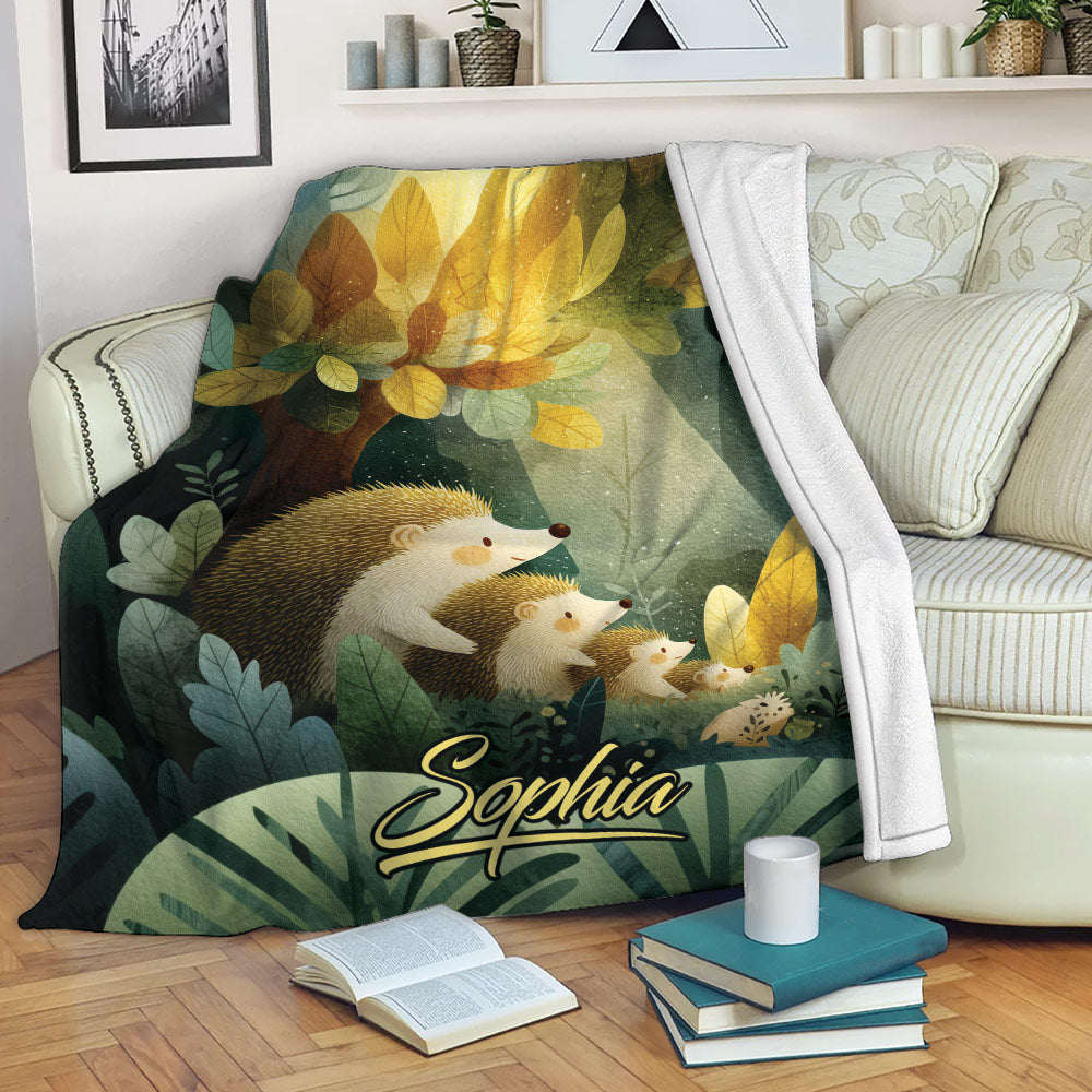 Hedgehog throw blanket displayed on a sofa with leafy forest artwork